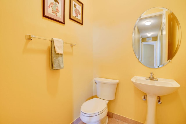 bathroom featuring toilet and tile patterned floors