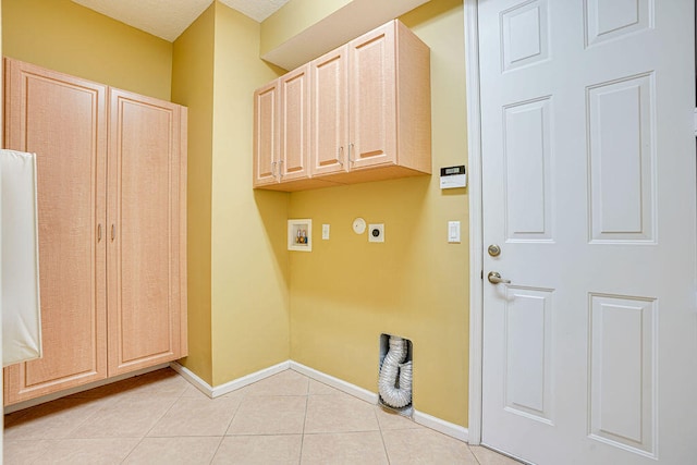 washroom with hookup for a washing machine, cabinets, light tile patterned floors, and hookup for an electric dryer