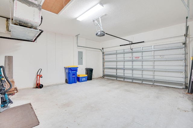 garage with electric panel and a garage door opener