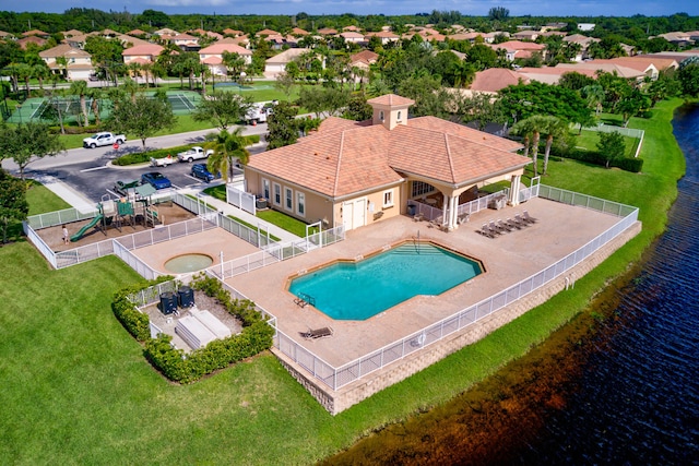 exterior space with a water view, a yard, a patio, and a playground