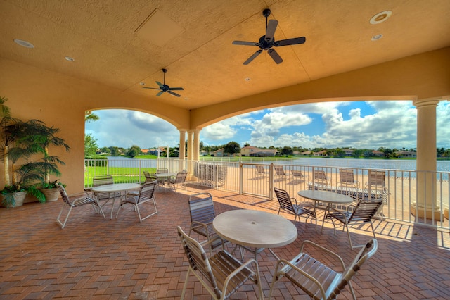 view of patio featuring ceiling fan and a water view