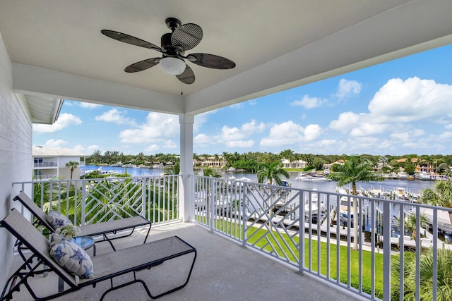 balcony featuring a water view and ceiling fan