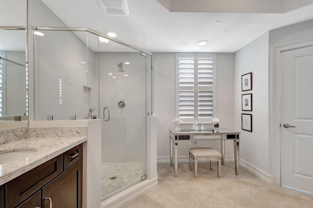 bathroom with vanity, a shower with shower door, and tile patterned flooring