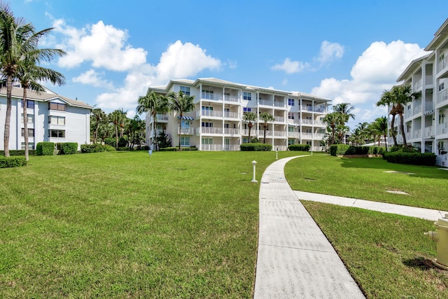 view of property's community with a lawn