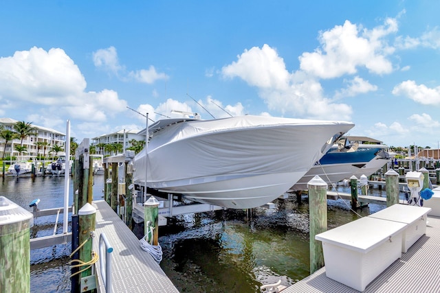 view of dock with cooling unit and a water view