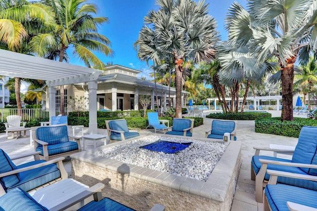 view of patio featuring an outdoor living space with a fire pit