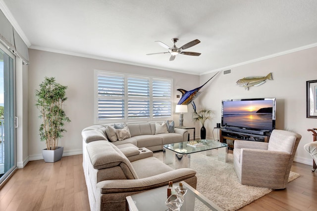 living room with crown molding, light wood-type flooring, and ceiling fan