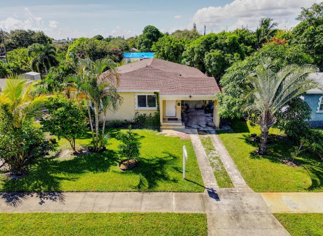 view of front of house with a front yard and a carport