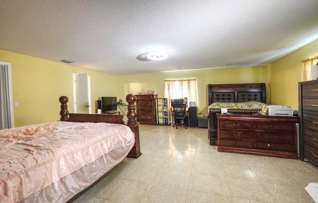 tiled bedroom with a textured ceiling