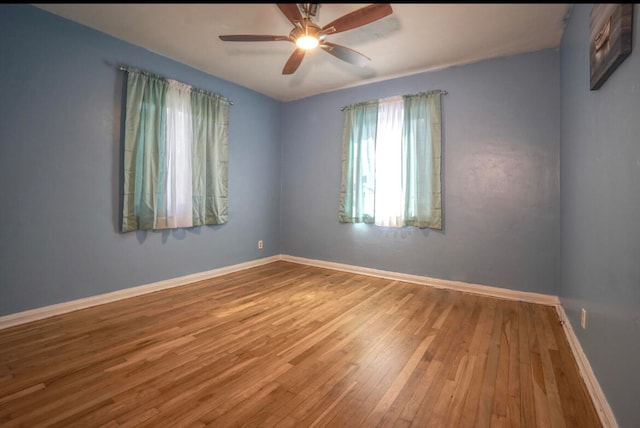 spare room with ceiling fan and hardwood / wood-style flooring