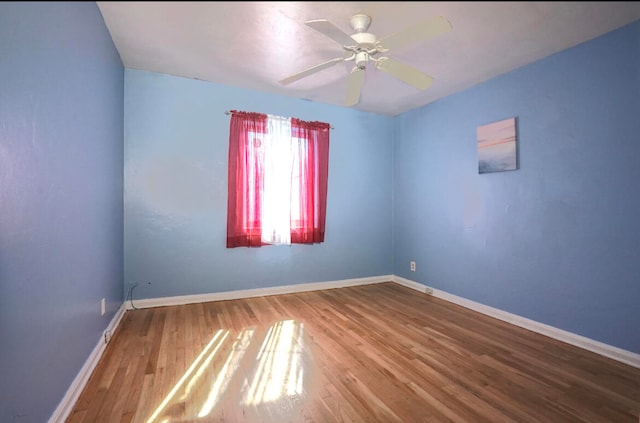 empty room featuring ceiling fan and hardwood / wood-style flooring