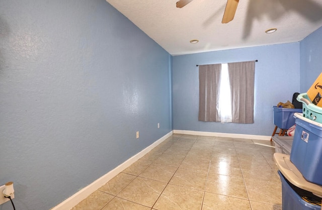 unfurnished room featuring ceiling fan and tile patterned floors