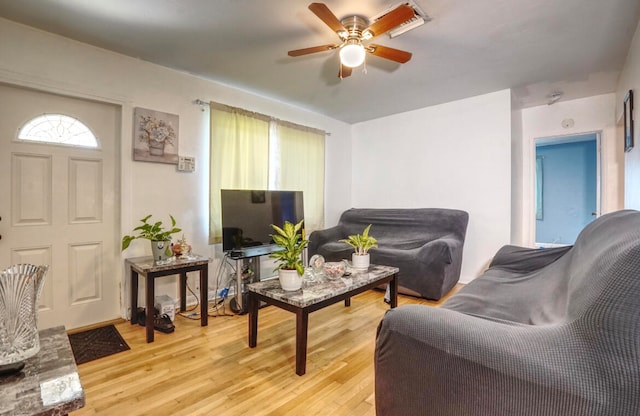 living room with light wood-type flooring and ceiling fan