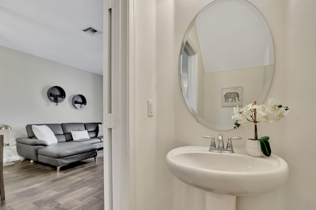 bathroom featuring wood-type flooring and sink