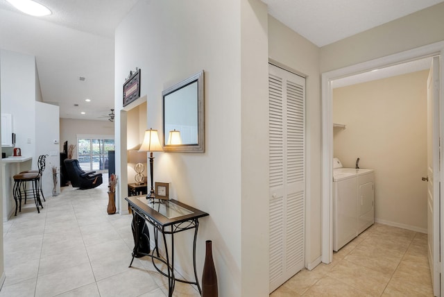 interior space featuring washer and dryer and light tile patterned flooring