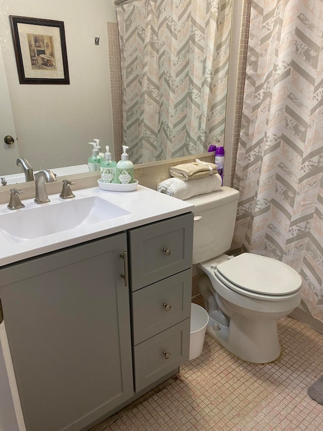 bathroom with vanity, toilet, and a shower with shower curtain