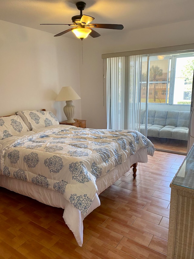 bedroom featuring hardwood / wood-style floors, access to exterior, and ceiling fan