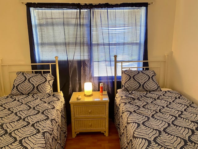 bedroom with dark hardwood / wood-style floors