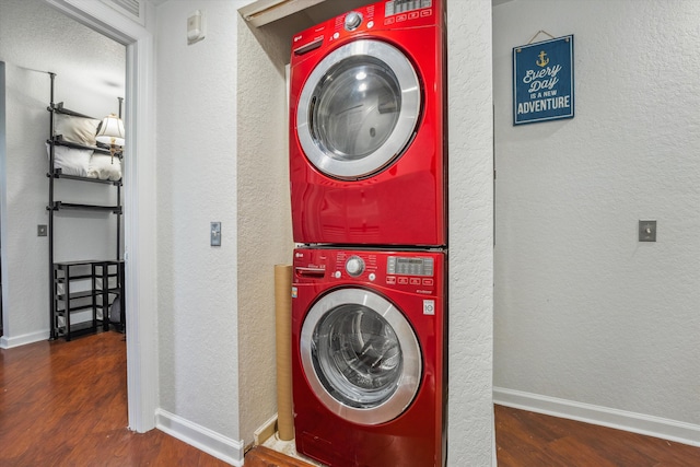 washroom featuring stacked washing maching and dryer, a textured ceiling, and hardwood / wood-style flooring