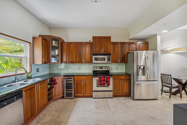 kitchen with sink, appliances with stainless steel finishes, backsplash, and wine cooler