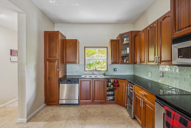 kitchen with decorative backsplash, sink, and appliances with stainless steel finishes