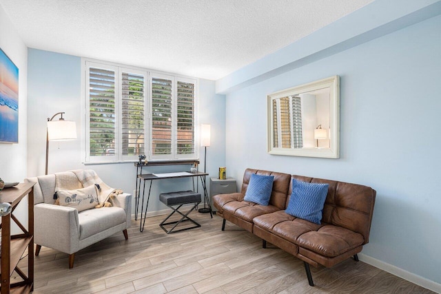 sitting room with a textured ceiling and light hardwood / wood-style floors