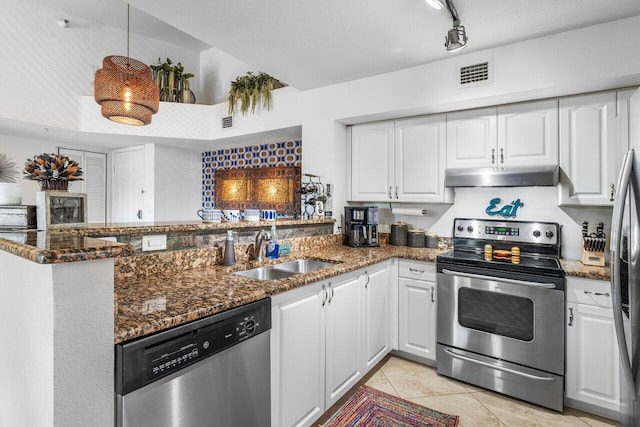 kitchen featuring white cabinets, dark stone countertops, sink, and appliances with stainless steel finishes