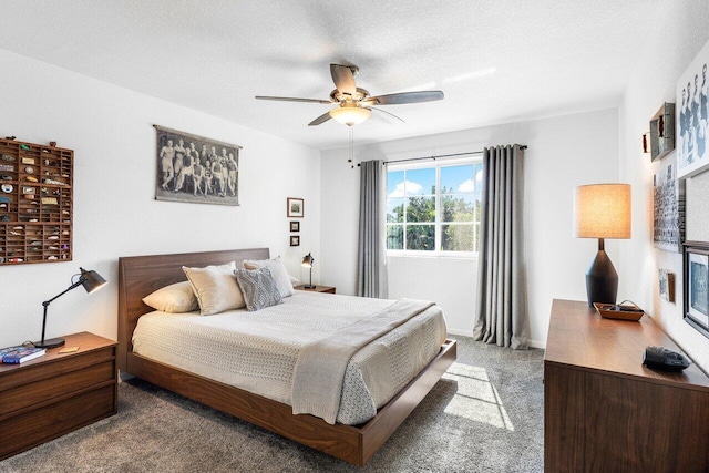 bedroom featuring ceiling fan, carpet floors, and a textured ceiling