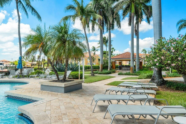 surrounding community with a gazebo, a pool, and a patio