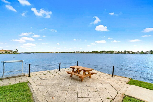 exterior space featuring a patio area and a water view