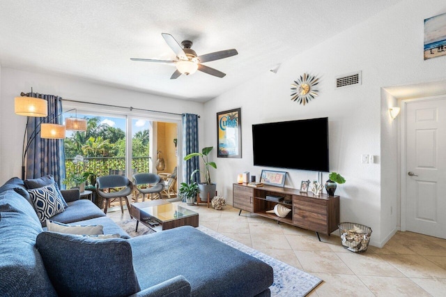 living room with light tile patterned floors, a textured ceiling, ceiling fan, and lofted ceiling