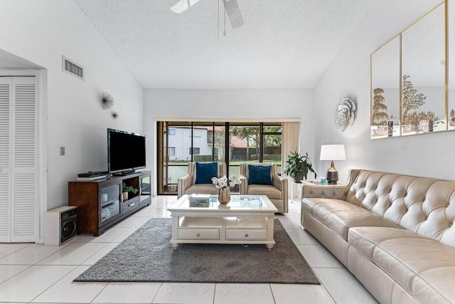 10 Via De Casas Sur Unit 104, Boynton Beach, FL 33426 - living area with lofted ceiling, a ceiling fan, a textured ceiling, and light tile patterned flooring