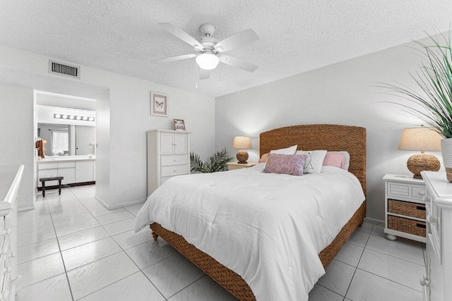 bedroom with ceiling fan, a textured ceiling, and light tile patterned floors