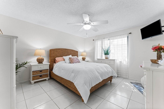 bedroom featuring a textured ceiling, ceiling fan, and light tile patterned flooring