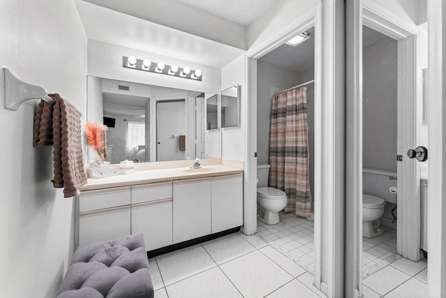 10 Via De Casas Sur Unit 104, Boynton Beach, FL 33426 - bathroom featuring toilet, vanity, and tile patterned floors