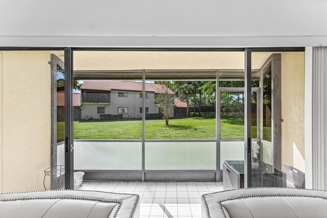 doorway to outside featuring light tile patterned flooring