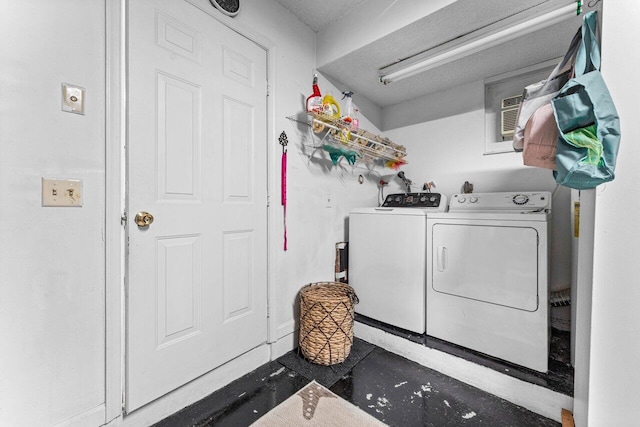 laundry area featuring a textured ceiling and separate washer and dryer