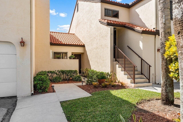 10 Via De Casas Sur Unit 104, Boynton Beach, FL 33426 - property entrance featuring a tiled roof and stucco siding