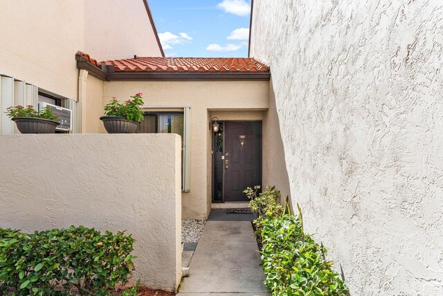 10 Via De Casas Sur Unit 104, Boynton Beach, FL 33426 - doorway to property with stucco siding and a tiled roof