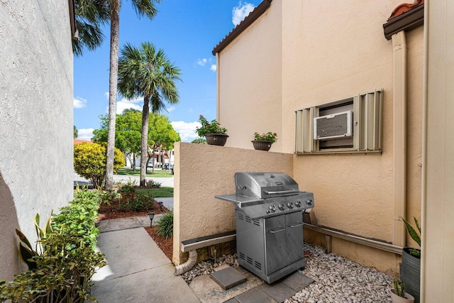 view of patio / terrace featuring a grill and cooling unit