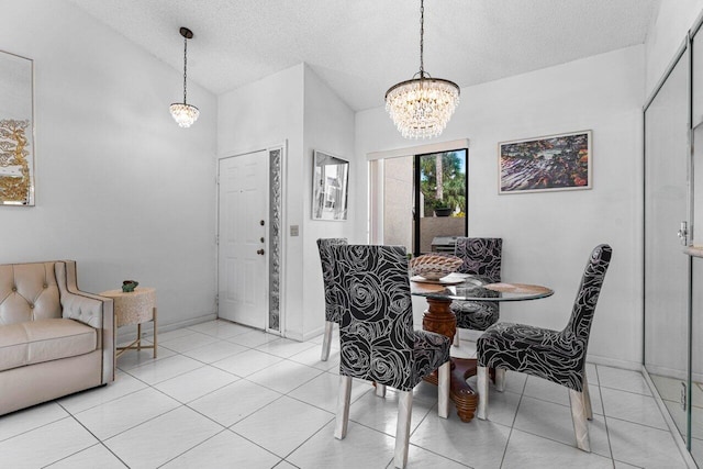 dining area featuring an inviting chandelier, a textured ceiling, and light tile patterned floors