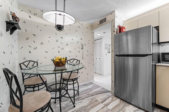 10 Via De Casas Sur Unit 104, Boynton Beach, FL 33426 - dining area with light marble finish floors and a textured ceiling