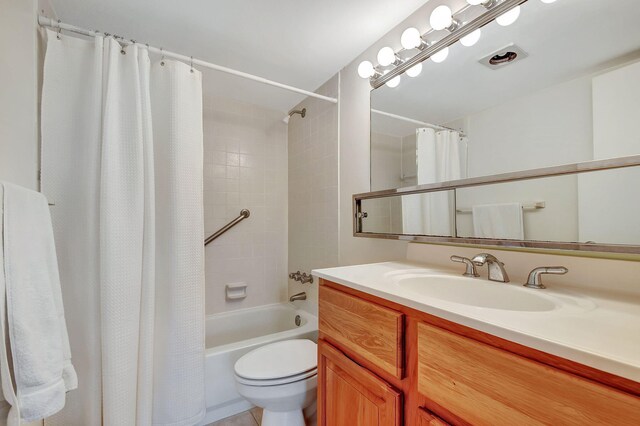 full bathroom featuring tile patterned floors, shower / bath combo, toilet, and vanity