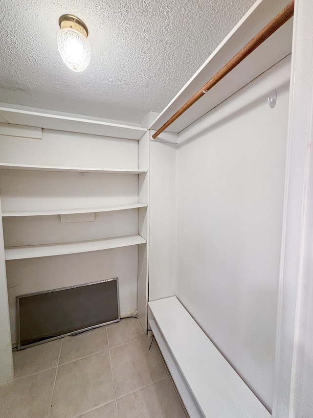 spacious closet with light tile patterned floors