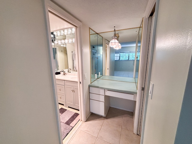 bathroom featuring vanity, a textured ceiling, and tile patterned flooring