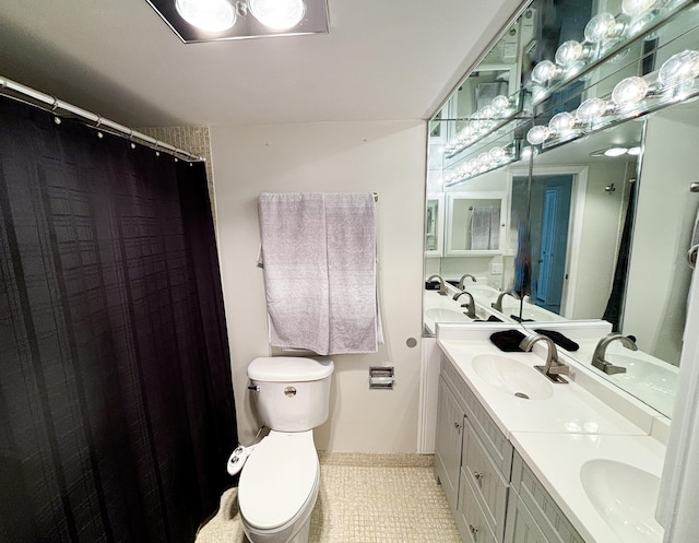 bathroom with tile patterned flooring, toilet, and vanity