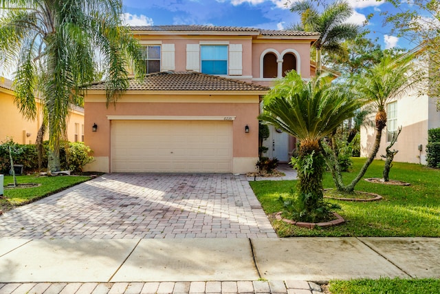 mediterranean / spanish-style house with a garage and a front yard