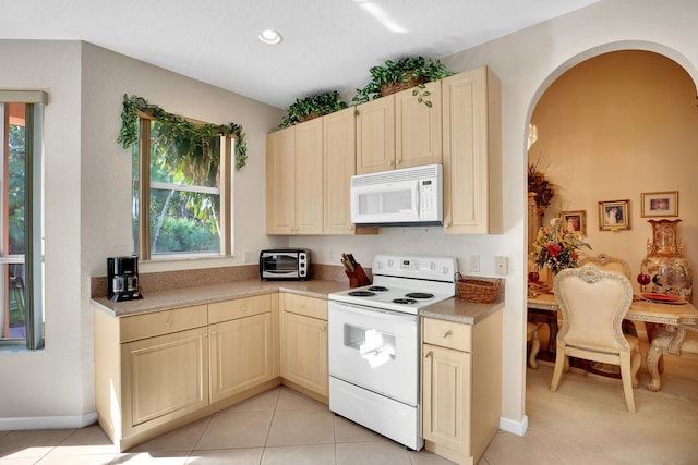 kitchen with white appliances and light tile patterned flooring