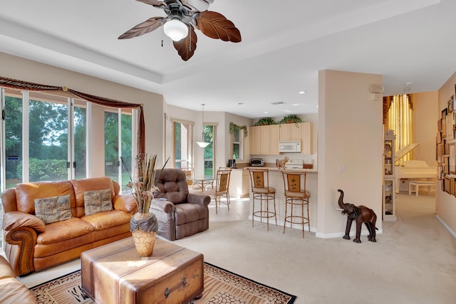 living room with ceiling fan and light carpet