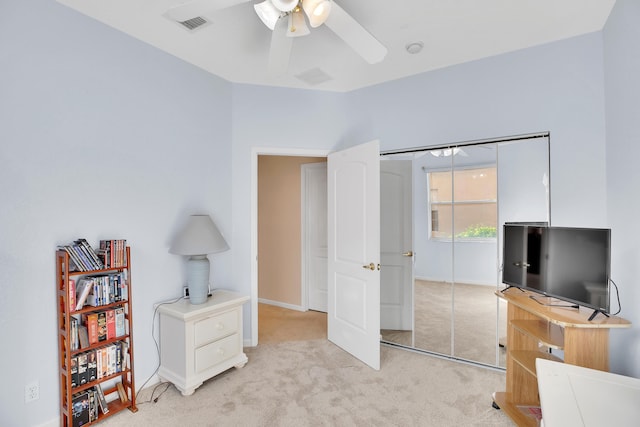 interior space with ceiling fan and light carpet